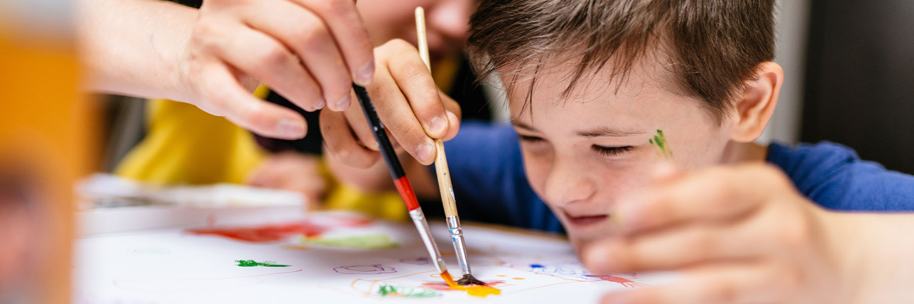 A teacher and student painting together